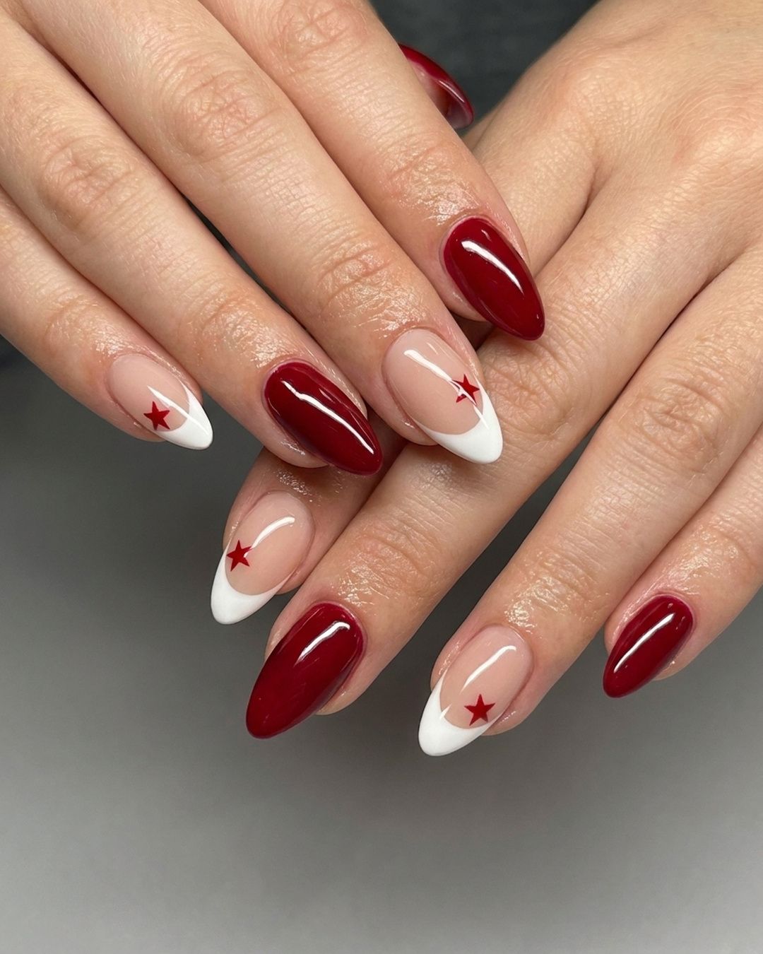Burgundy French nails with star accents at V Nails Red Deer
